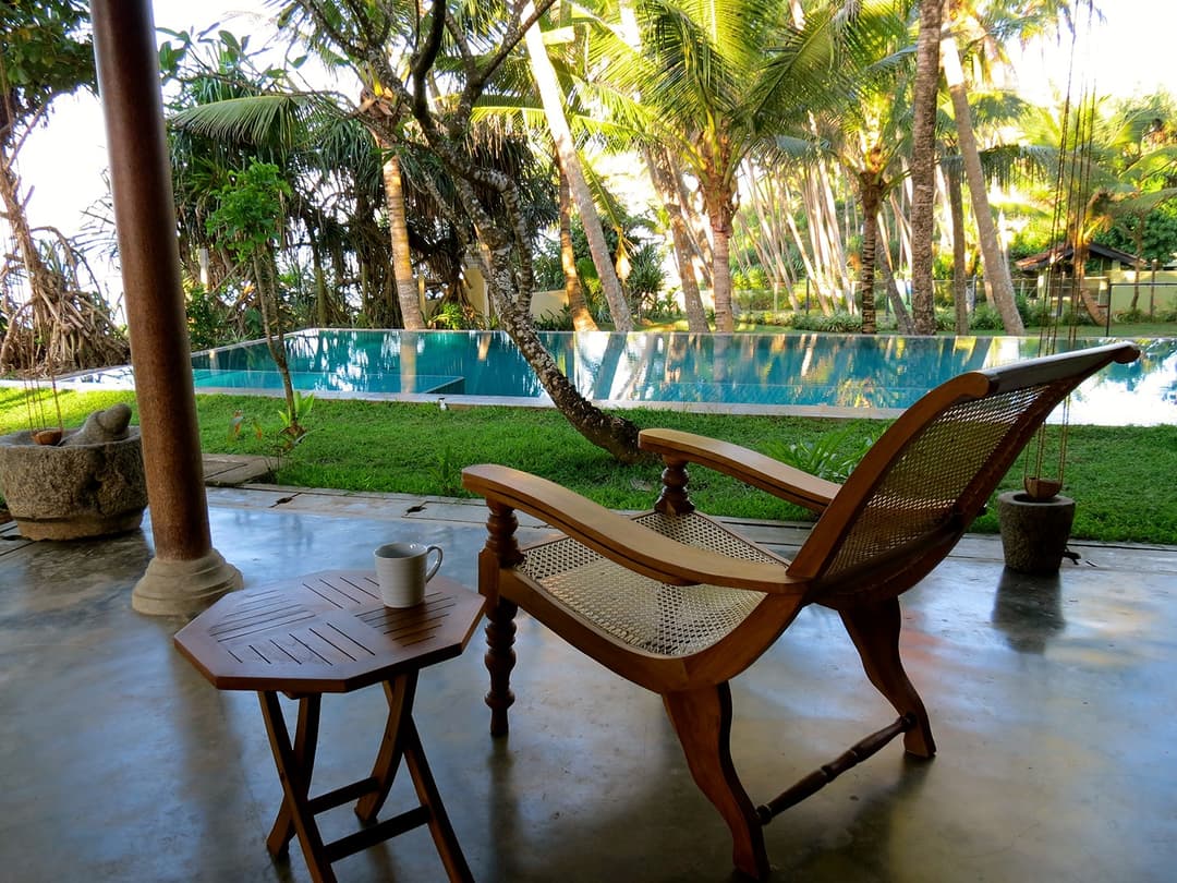 Matara villa outside planter chair overlooking pool and Indian Ocean
