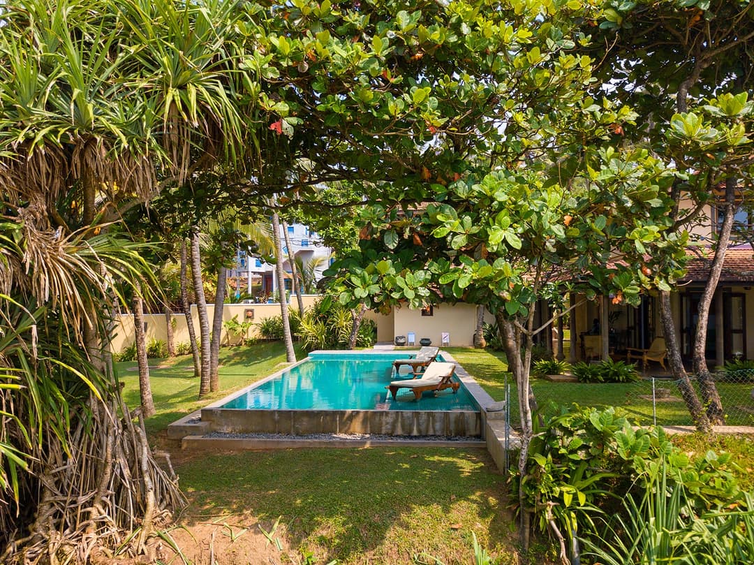 Matara villa pool view from elevated cliff position with garden and ocean