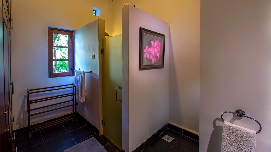 Matara villa poolside room bathroom with shower fittings and wall