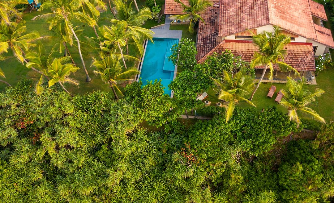Villa Tres Matara aerial drone view with lush garden and beach beyond