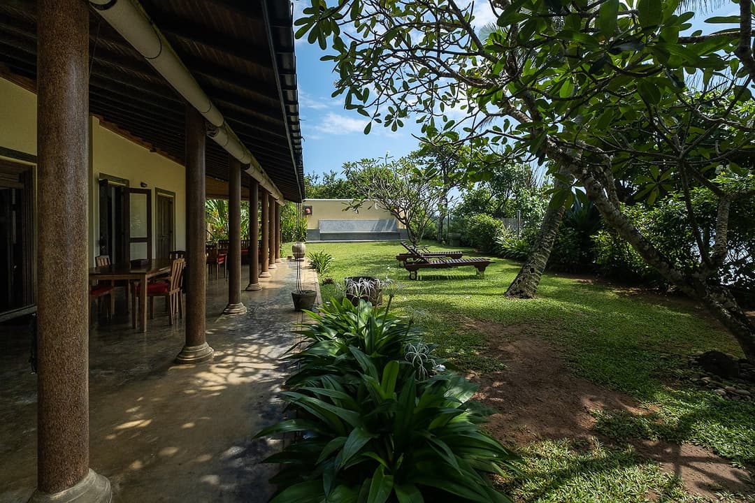 Villa Tres Matara exterior with covered veranda and tropical garden path