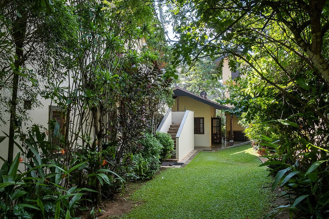 Villa Tres Matara garden path through coconut grove to villa exterior