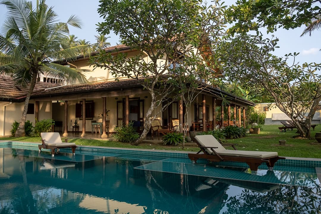 Villa Tres Matara pool and exterior daytime with garden and sun loungers