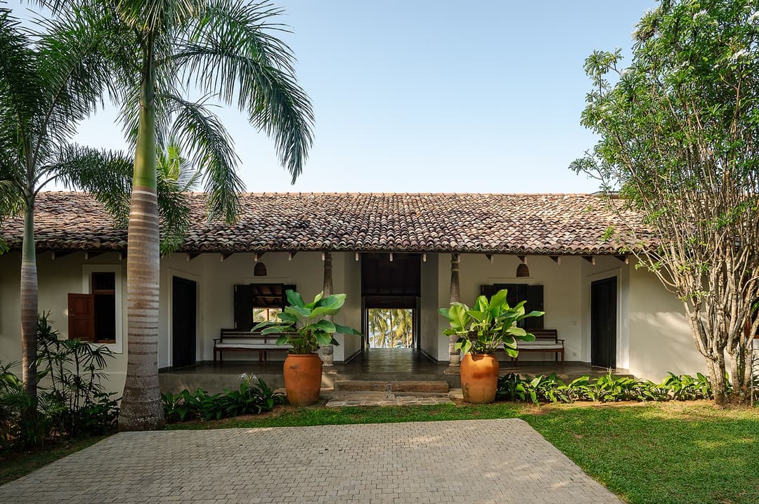 Covered walkway and garden courtyard connecting the two buildings at Pavana Hiriketiya villa