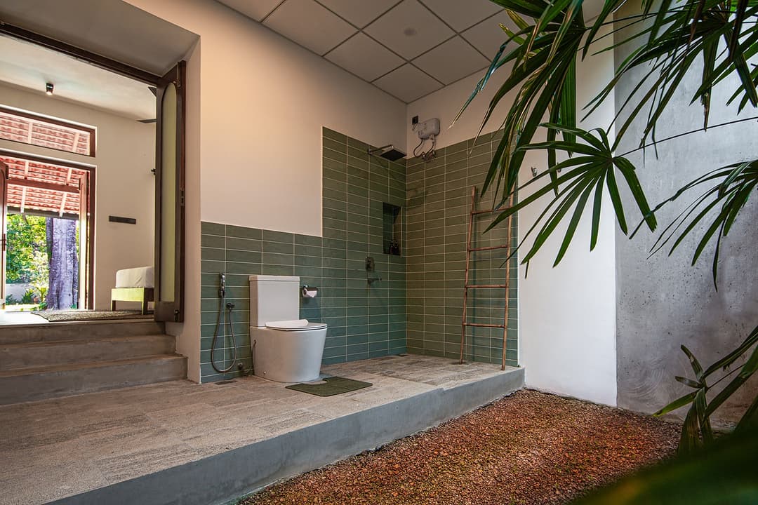 Ensuite bathroom with rain shower and patterned floor tiles