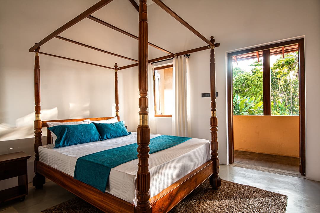 Origin Balapitiya bedroom with canopy bed and pool view