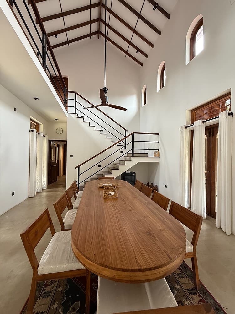 Origin Balapitiya open-plan dining and living area with wooden table