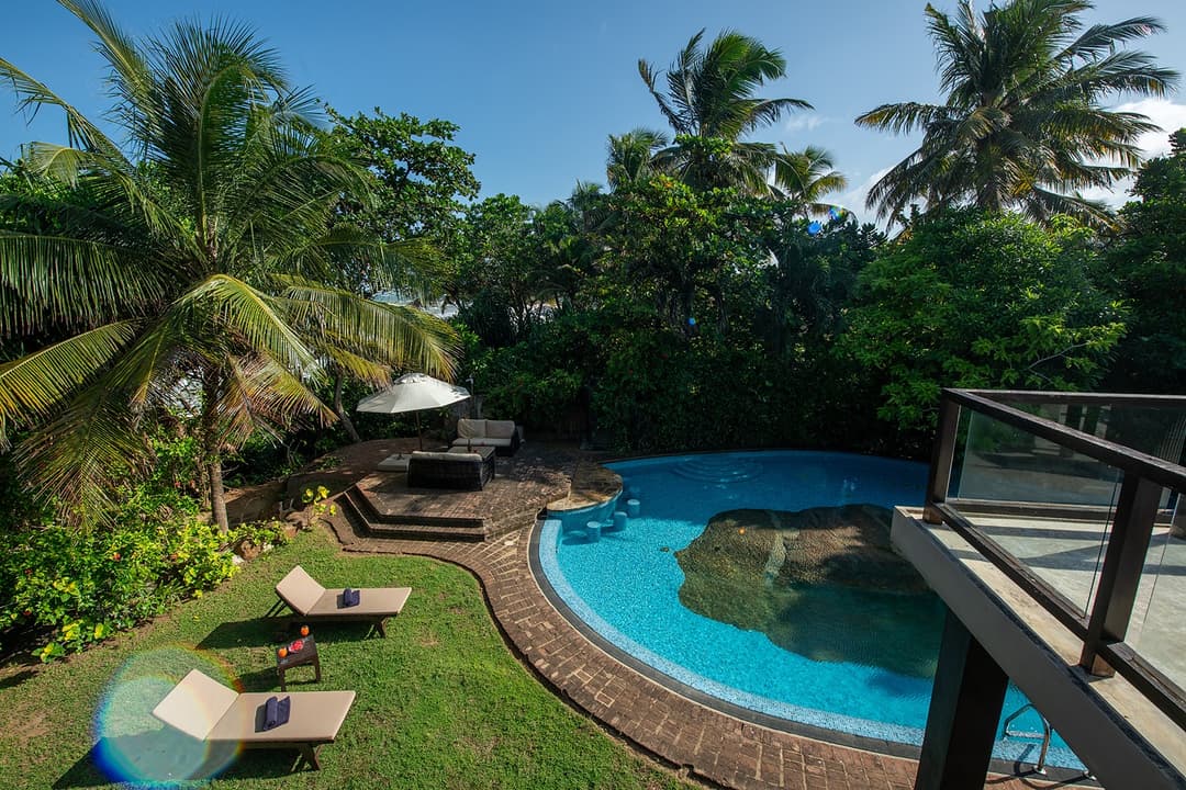 Casa Tua pool with turquoise water and garden under blue sky