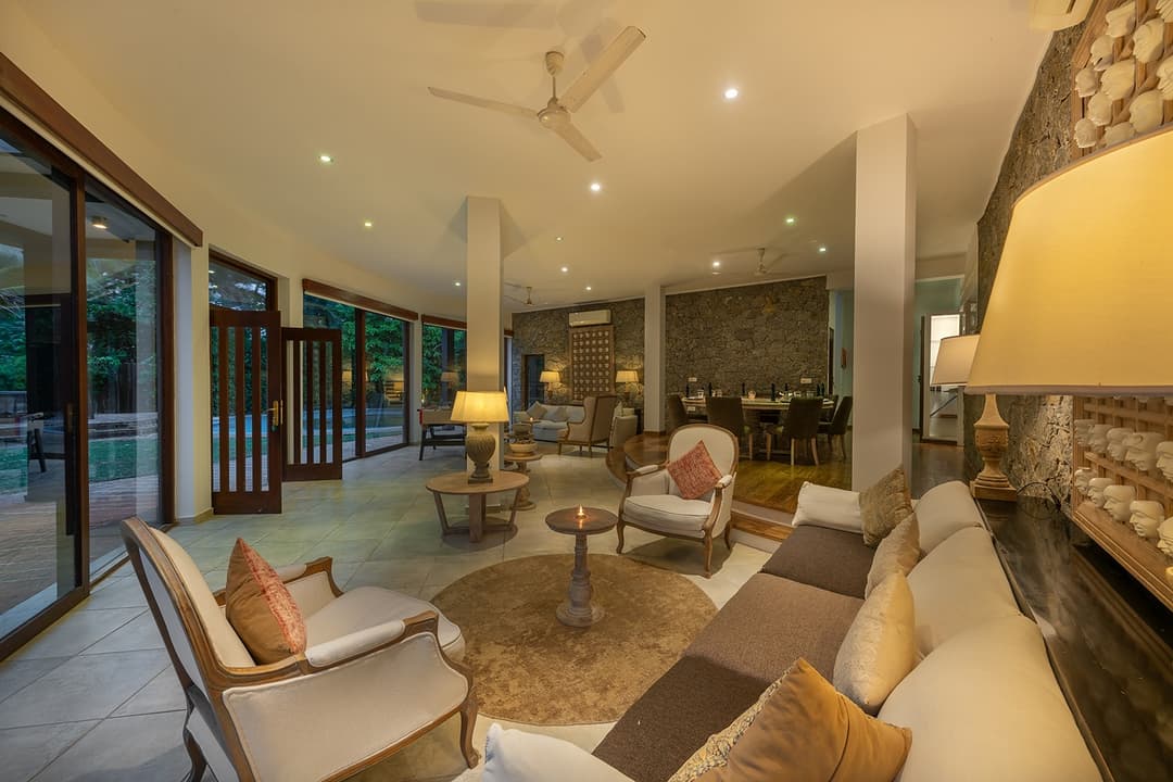 Casa Tua pool terrace illuminated at evening with dining area