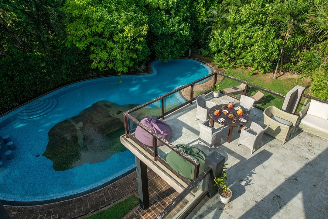 Casa Tua pool with natural rock formation and ocean view from above