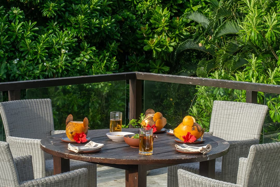 Outdoor breakfast on ocean-view terrace with fresh fruit