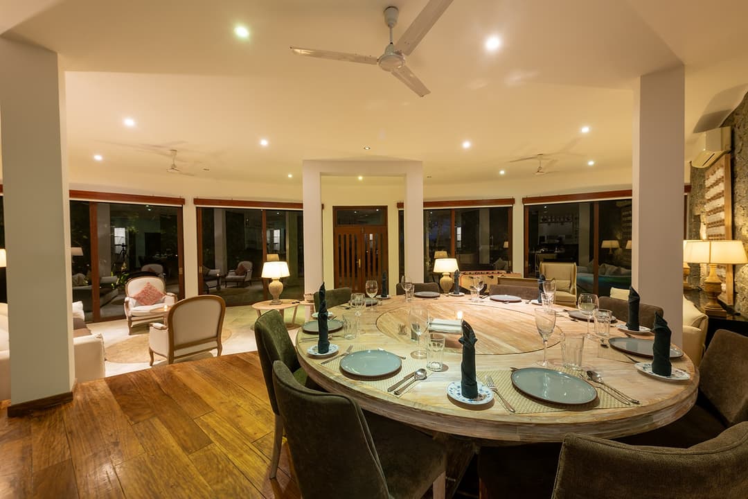 Casa Tua open-plan living and dining area with evening lights