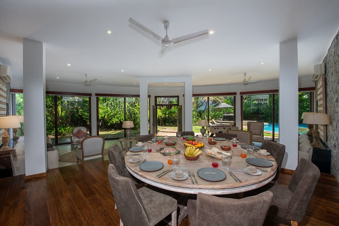 Casa Tua dining room with round table set for evening meal