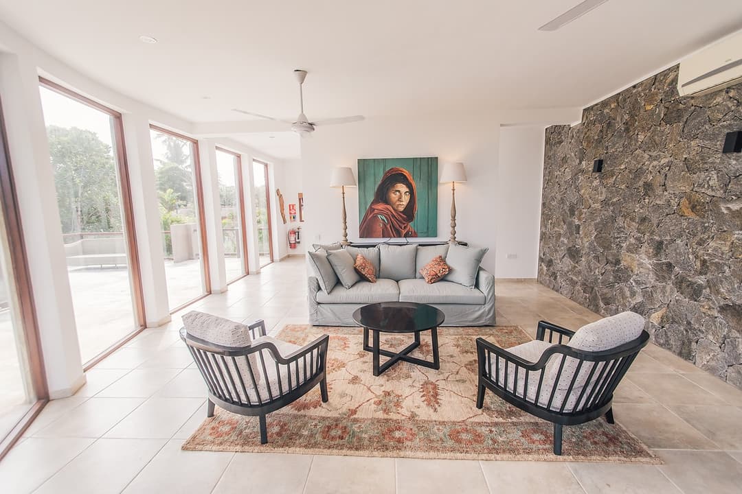 Upper bedroom with balcony access and coastal artwork