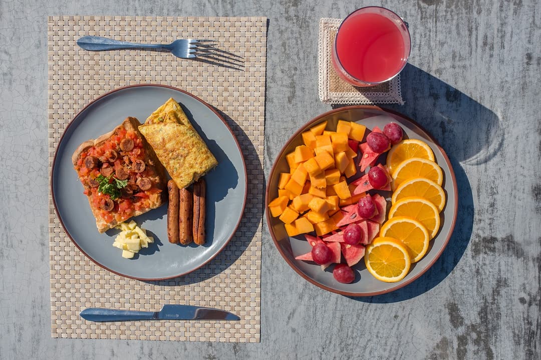 Tropical fruit breakfast platter with fresh juice poolside