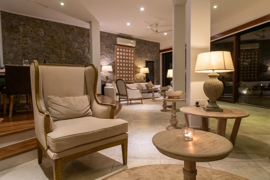 Sitting area with rattan chairs and warm ambient light