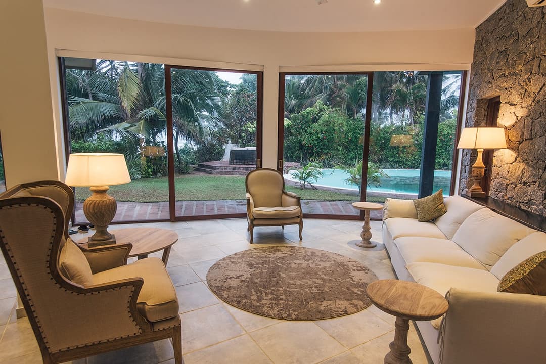 Reading corner with floor lamp and ocean view through glass
