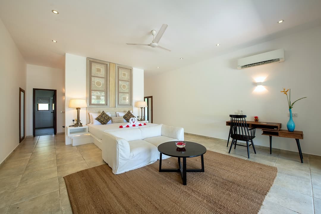 Open-plan bedroom with king bed and ac