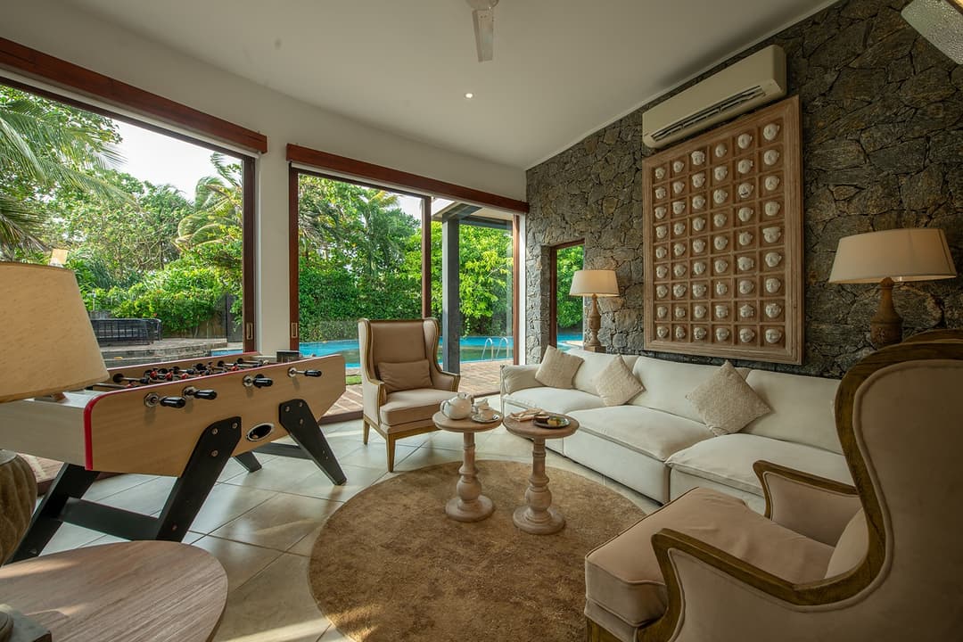 Villa lounge with neutral tones and garden view