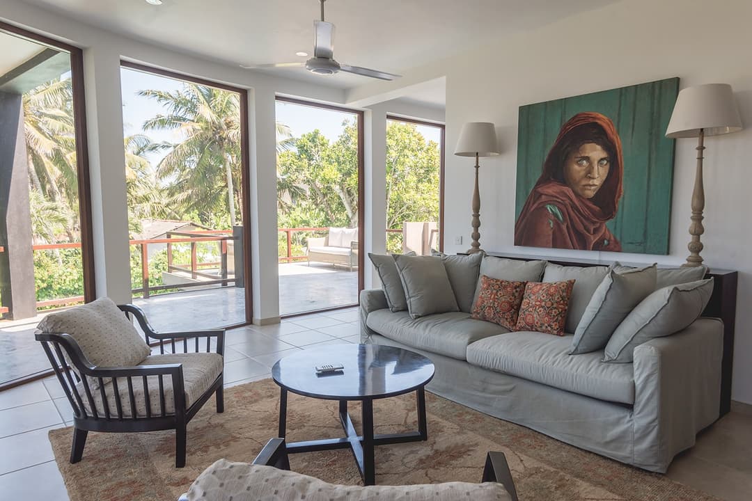 Villa living room with sofa opening onto garden terrace