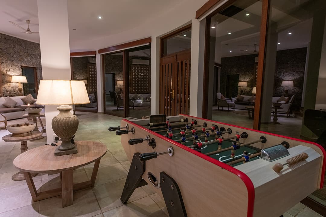 Villa games room with foosball table and lounge seating