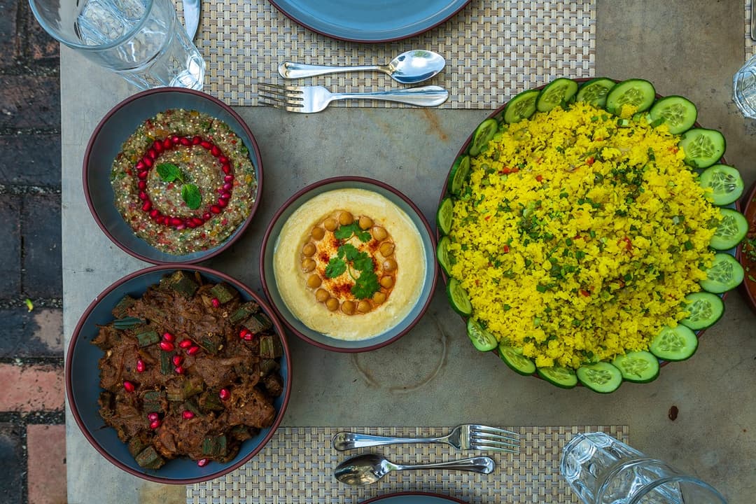 Fresh salad bowls and colourful dishes on garden dining table