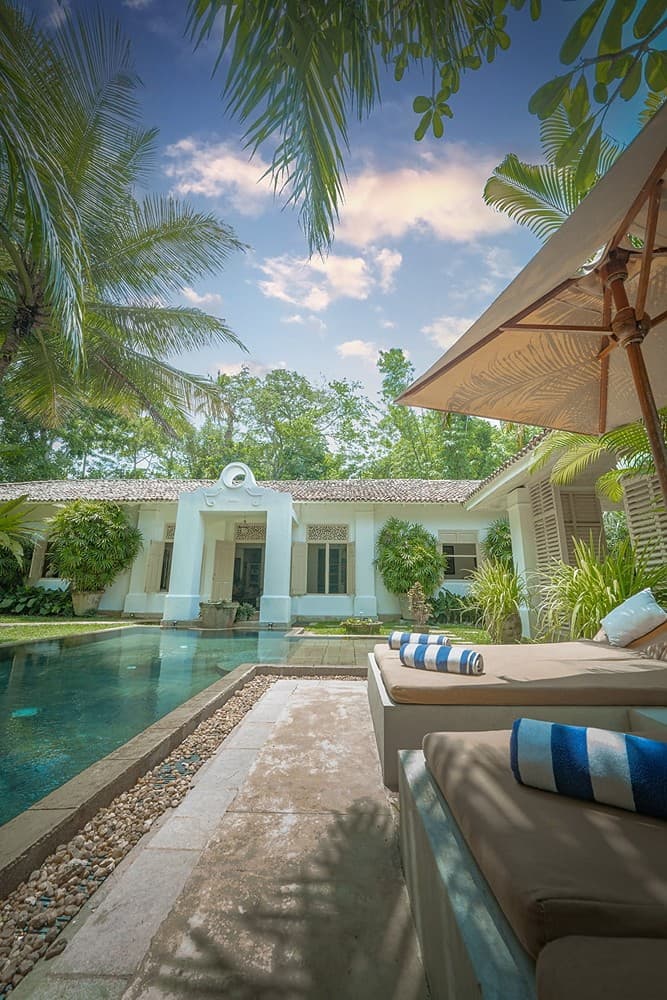 Rivers Edge open-plan living area with pool view through timber frame