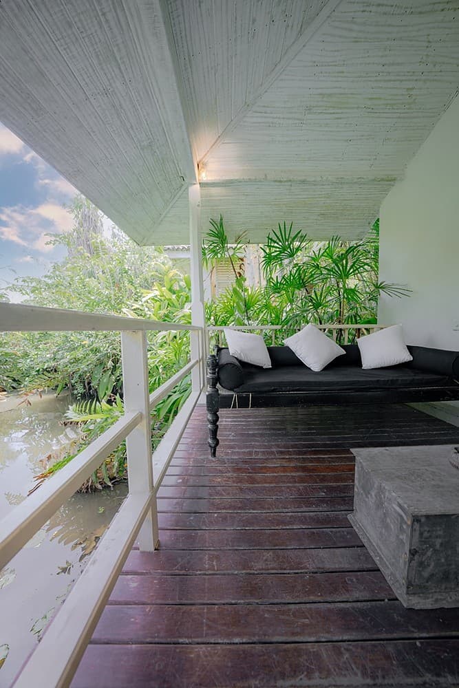 Rivers Edge master bedroom with four-poster bed and garden view