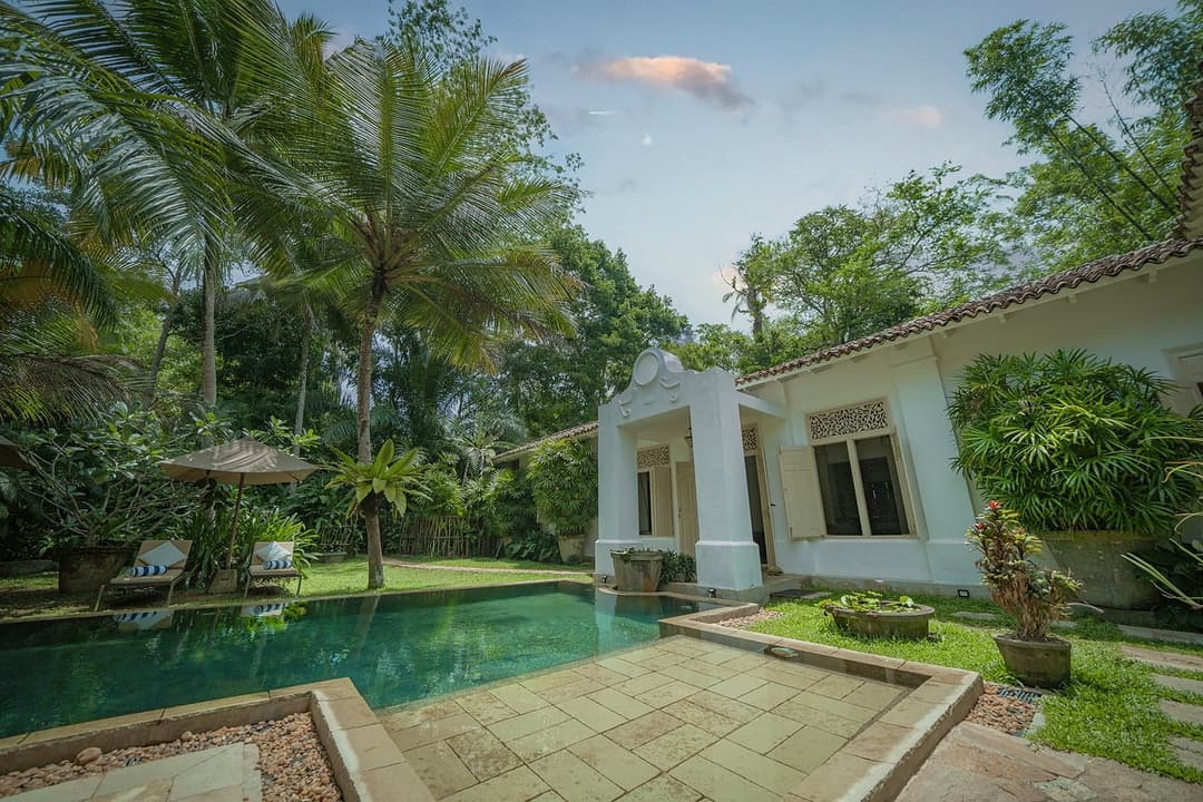 Rivers Edge garden lawn with pool and colonial facade