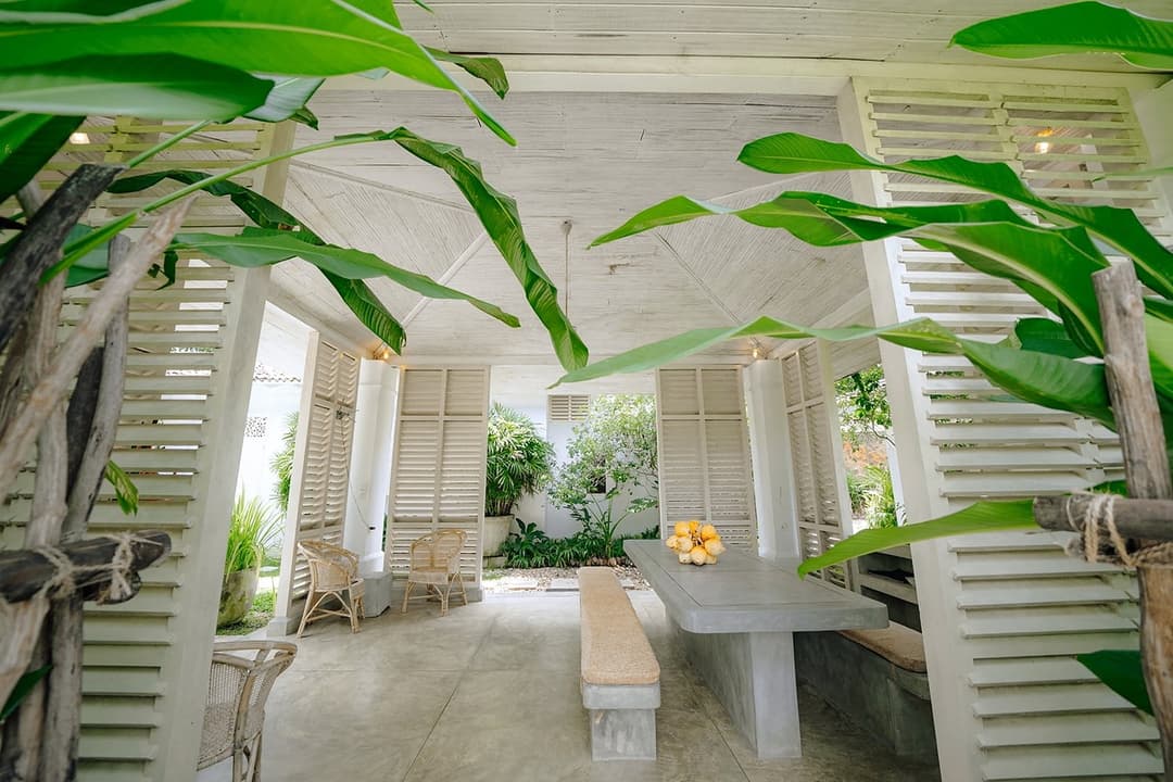 Rivers Edge colonial veranda with tropical planting and stairs