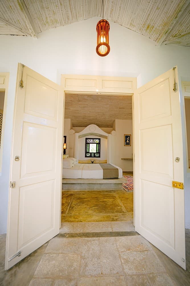 Ensuite bathroom with white interior and glass door