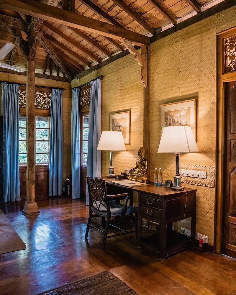 Bedroom with writing desk and framed artwork on wall
