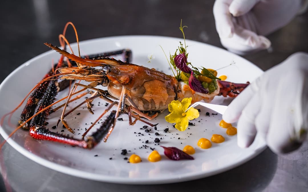 Fine dining plated lobster with edible flowers