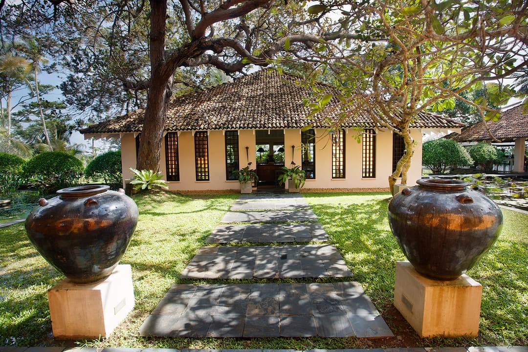 Kahanda Kanda property exterior with stone urns and garden