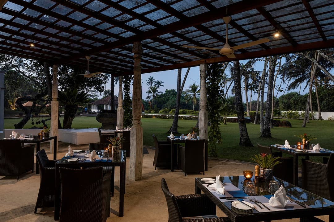 Verandah with rattan seating and garden outlook at Heritage House Bentota, Sri Lanka