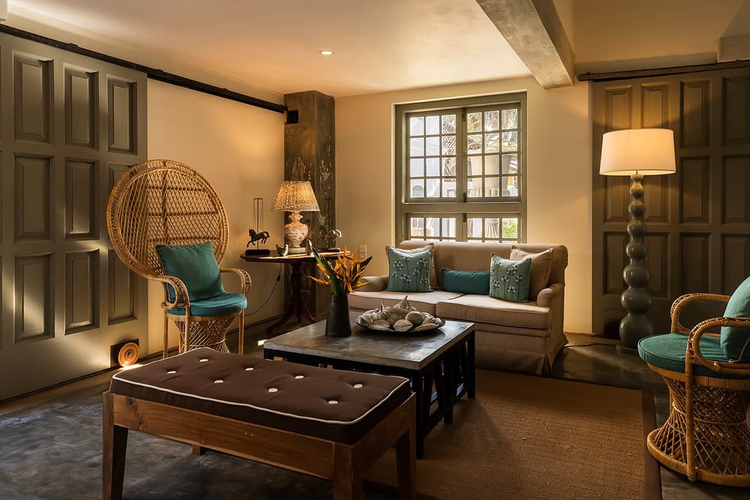 Lobby lounge with rattan peacock chairs and colonial furniture at Heritage House Bentota