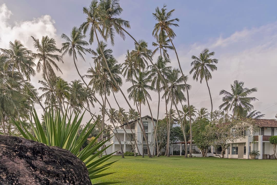 Heritage House Bentota manicured garden against white building facade