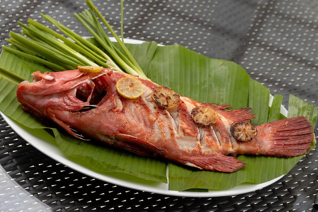 Whole grilled fish on banana leaf from Heritage House Bentota restaurant, Sri Lanka