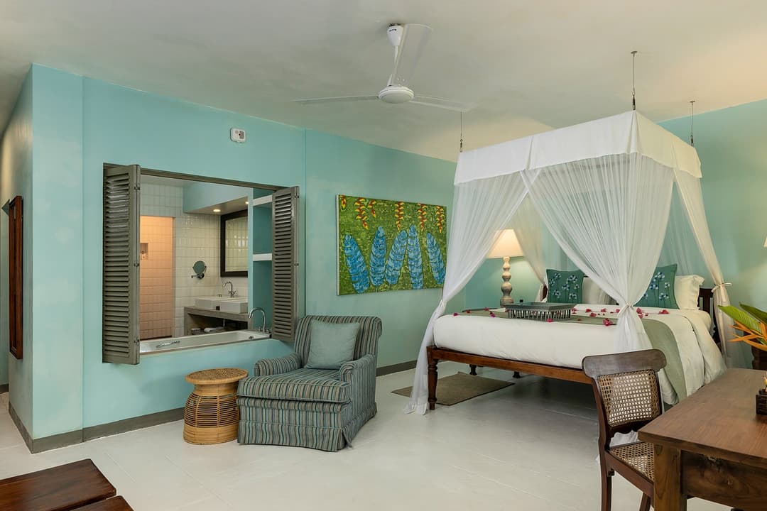 Teal and sage bedroom with canopy bed and fresh palette at Heritage House Bentota, Sri Lanka