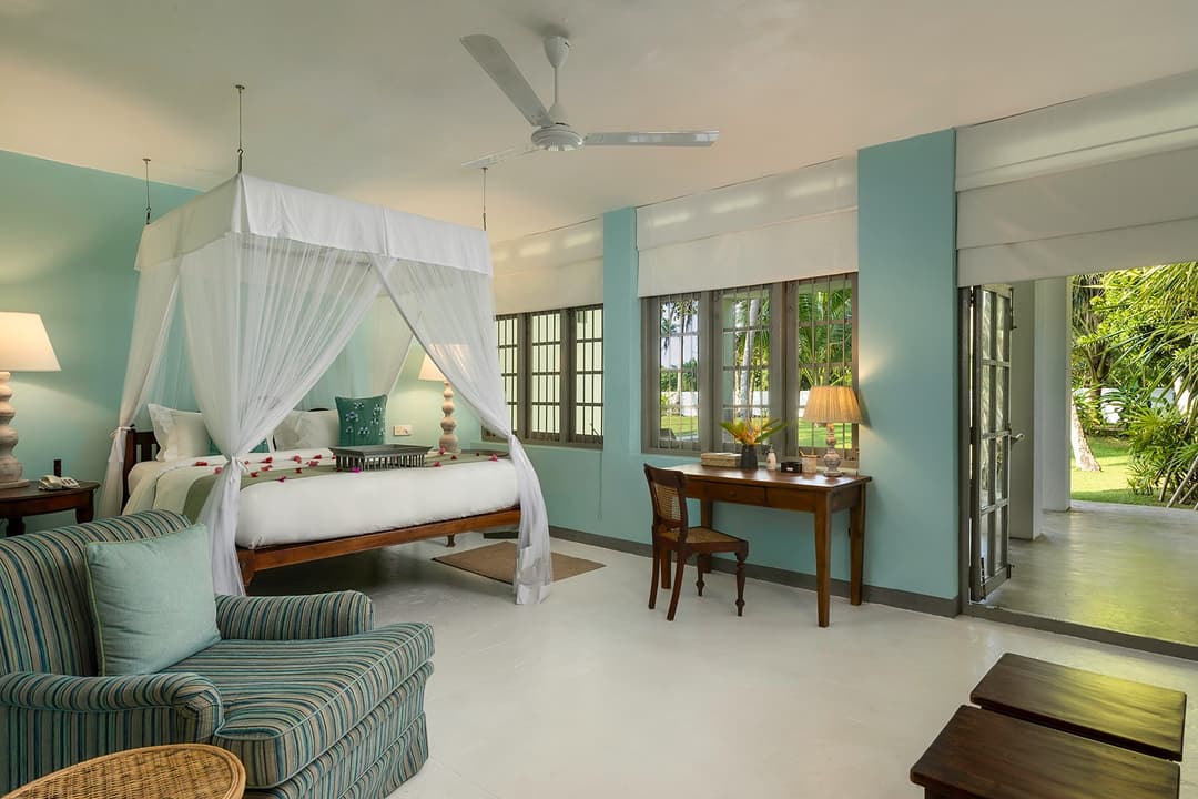 Teal canopy bedroom with soft furnishings and natural light at Heritage House Bentota