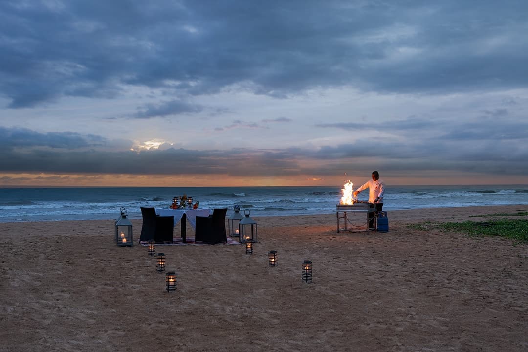 Beach BBQ at Heritage House Bentota with lanterns and open fire on Bentota beach at night