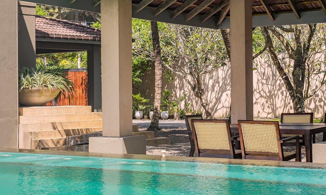 Poolside view through pavilion columns to Indian Ocean at Cottage Kabalana, Ahangama
