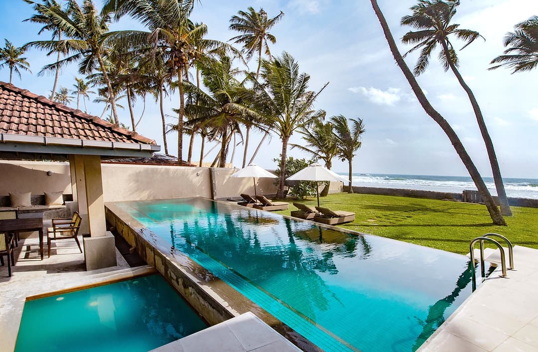 Cottage Kabalana pool with coconut palms and beachside pavilion, Ahangama, Sri Lanka