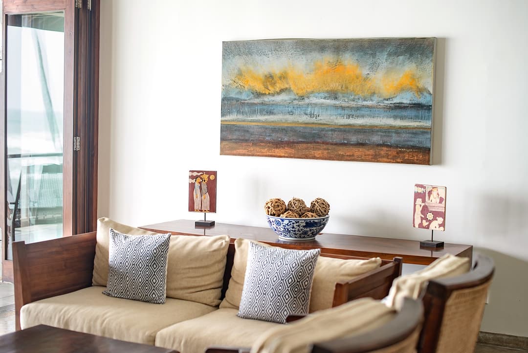 Lounge with sofa and original artwork at Cottage Kabalana, Ahangama, Koggala, Sri Lanka