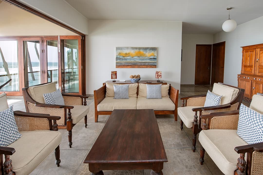 Wide living room with sofa set and artwork at Cottage Kabalana, Ahangama, Sri Lanka