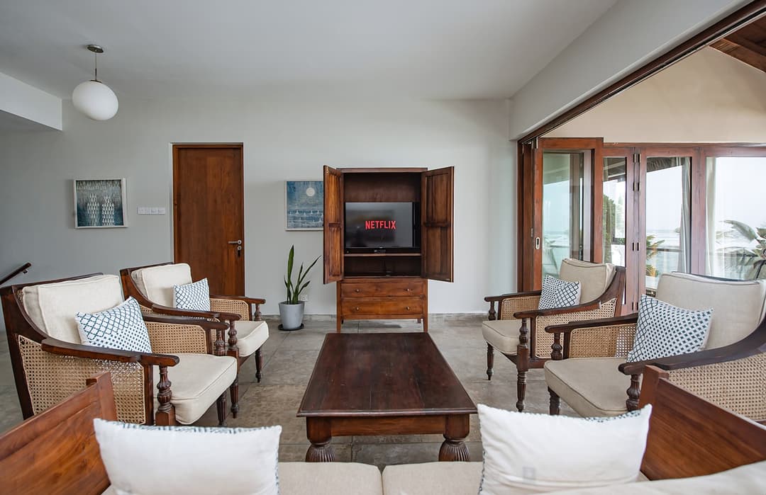 Living room with colonial timber furniture and TV unit at Cottage Kabalana, Ahangama