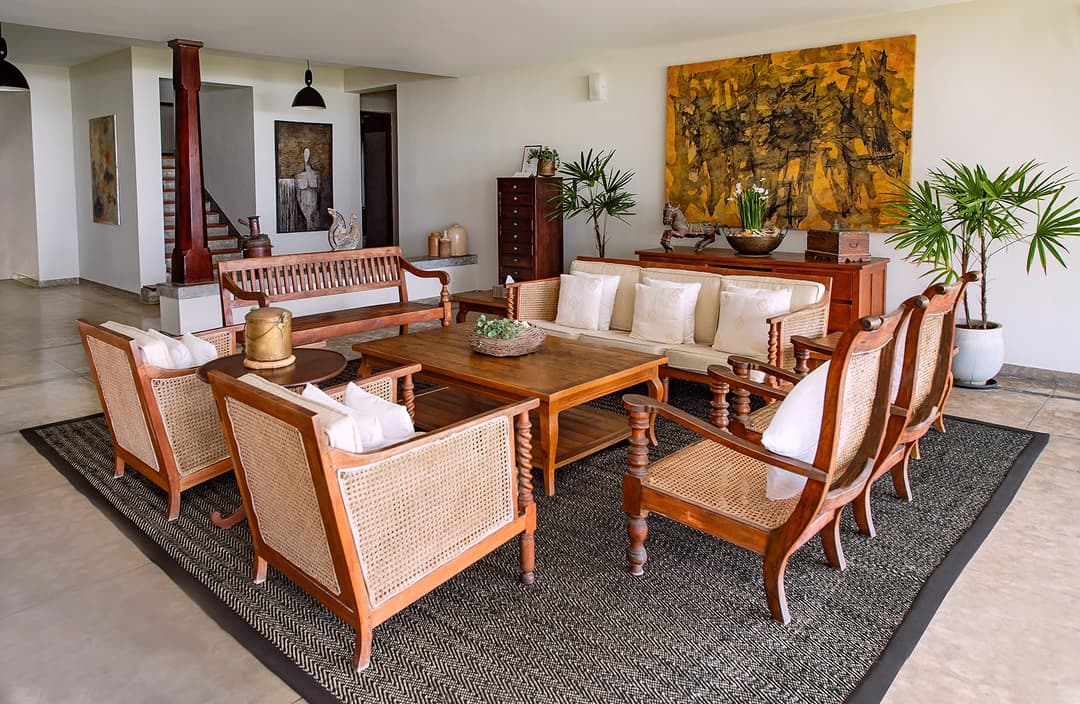 Living room with large abstract artwork and colonial seating at Cottage Kabalana, Ahangama