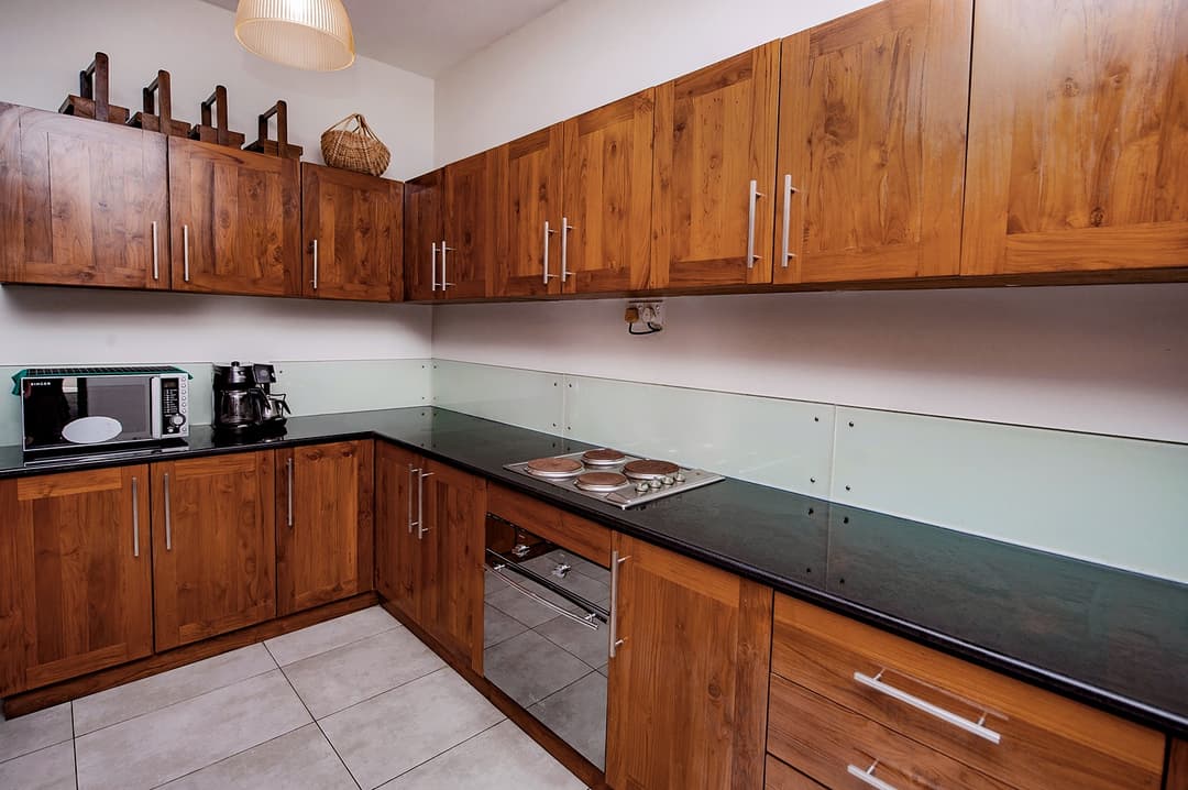 Fully equipped kitchen with dark timber cabinetry at Cottage Kabalana, Ahangama, Sri Lanka