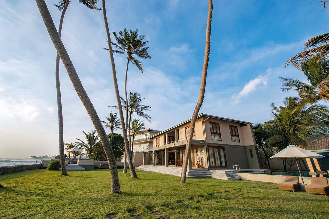 Cottage Kabalana exterior with tropical garden and coconut palms, Ahangama, Sri Lanka
