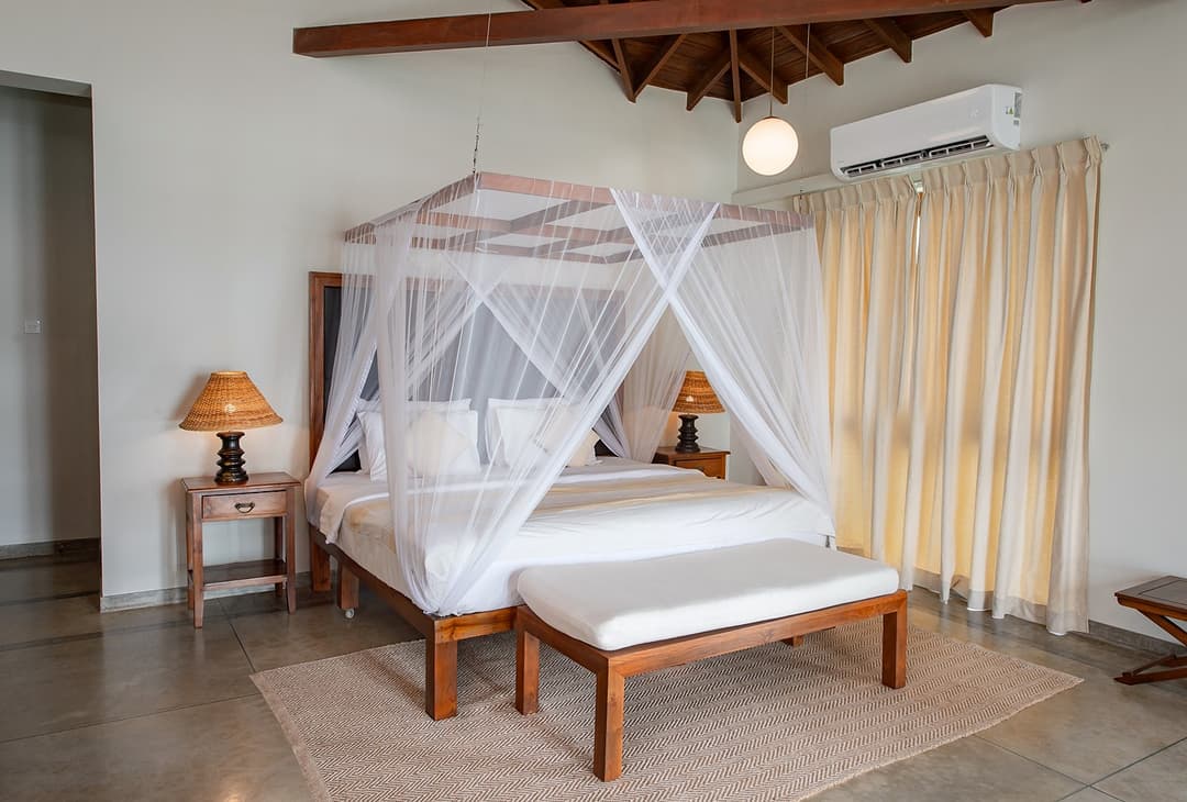 Cottage Kabalana bedroom with four-poster canopy bed and cream coastal tones, Ahangama